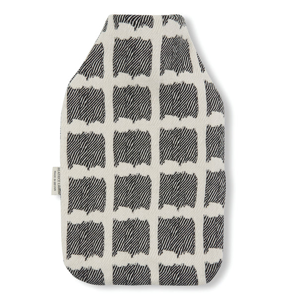 Beatrice Larkin weaved merino wool hot water bottle in Ikat black and cream pattern.