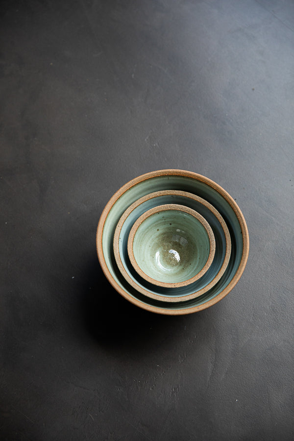 Handmade by the Leach Pottery Studio in St Ives. A set of three prepping bowls each one is glazed on the inside with a duck egg blue dolomite glaze. The outside is unglazed for a natural and organic feel. Neatly stacked inside each other in this photo