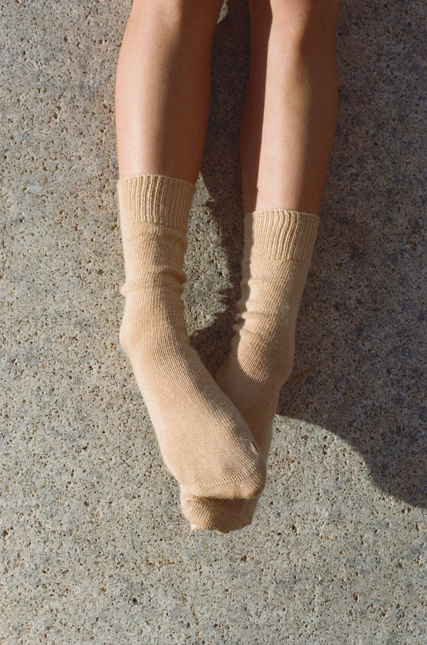 styled shoot floor image of feet wearing butter colour mohair Oaken socks available at Ash, Falmouth