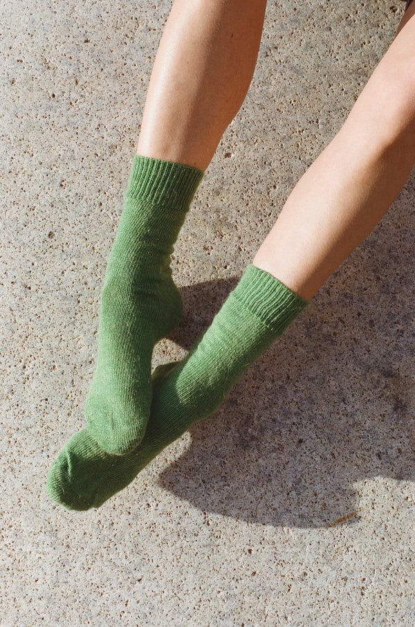 styled shoot floor image of feet wearing verdigris green mohair Oaken socks available at Ash, Falmouth