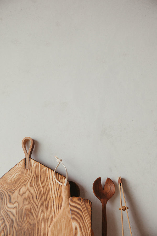 Ambrose Vevers scorched ash chopping board amongst other wooden items on display.