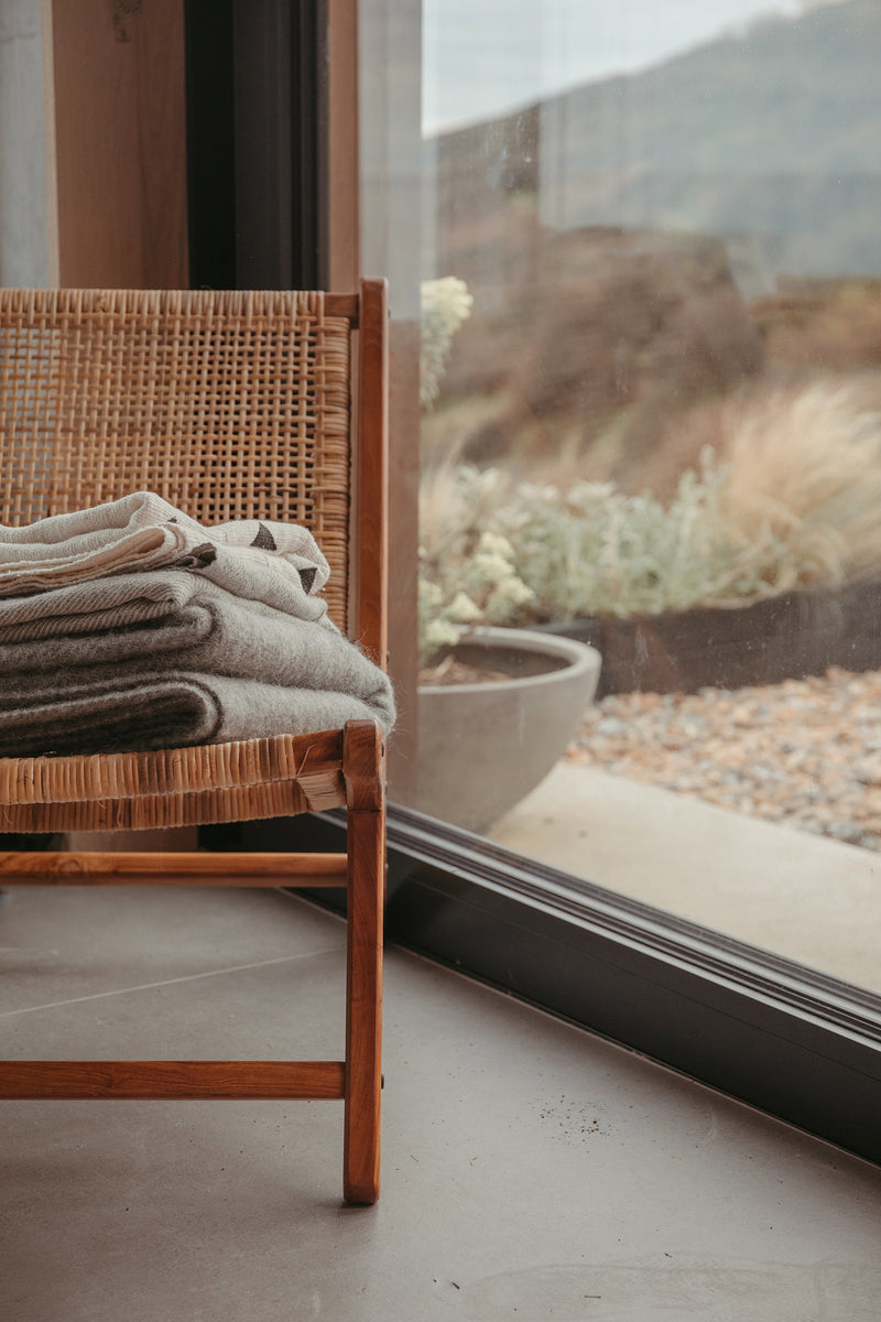 Grey colour lambswool and recycled wool blanket with tassel detail