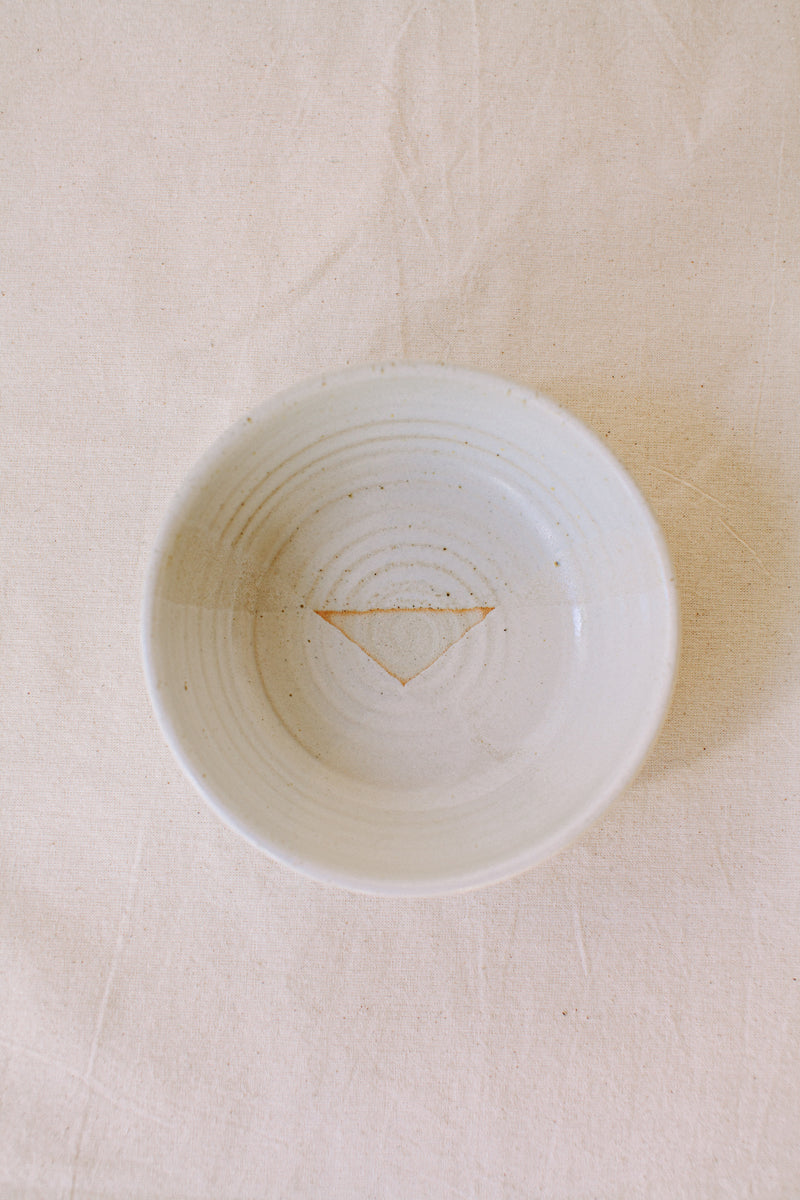 Handmade ceramic bowl by Liz Vidal. This bowl is the perfect size for breakfast, salads or soups. Liz uses different tones of white glaze to dip her bowls to create an abstract landscape design.