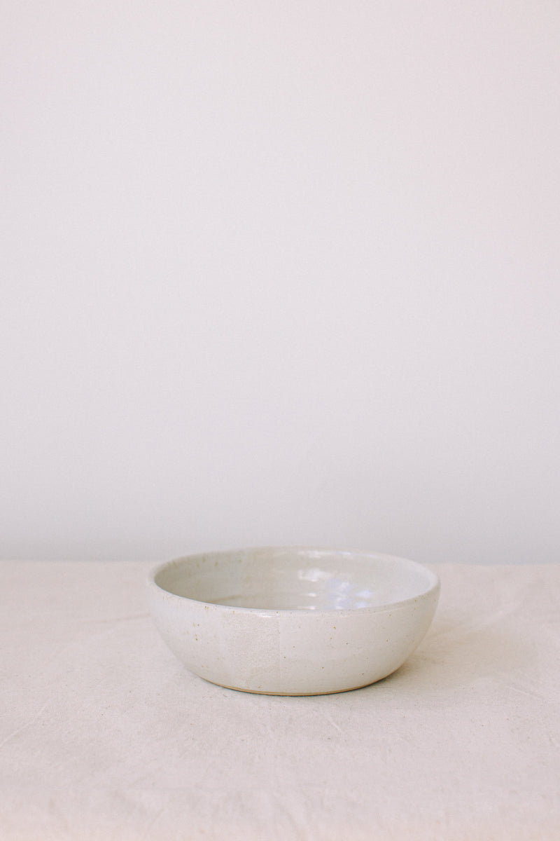 Handmade ceramic bowl by Liz Vidal. This bowl is the perfect size for breakfast, salads or soups. Liz uses different tones of white glaze to dip her bowls to create an abstract landscape design.