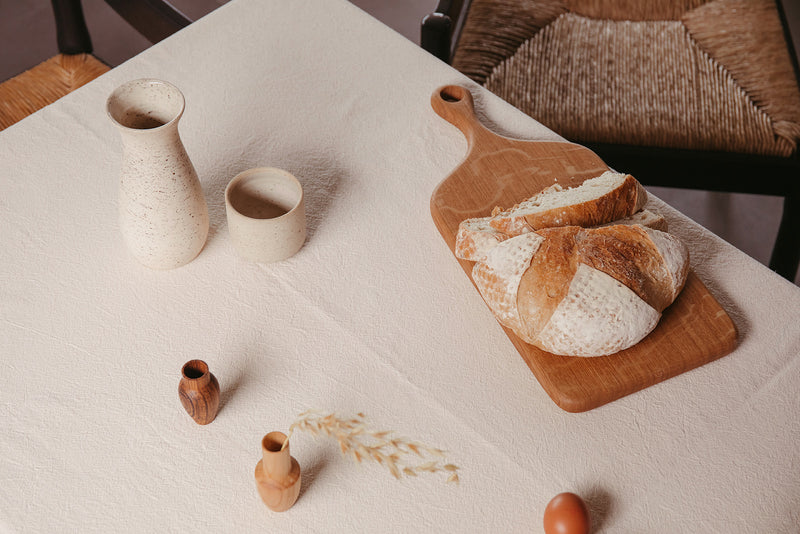 Handmade oak chopping board by Selwyn House, on a table with freshly cut sourdough bread