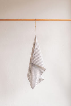 product shot of linen kitchen towel, grey and white stripe.